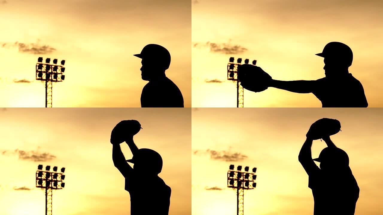 剪影棒球运动员随著夕阳苦练
