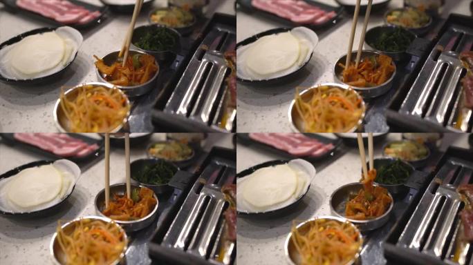 慢动作筷子抓住亚洲韩国烧烤食物边