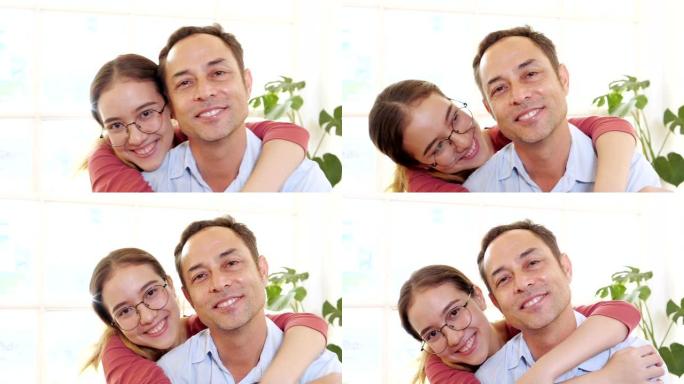 女儿在看电视时拥抱父亲。