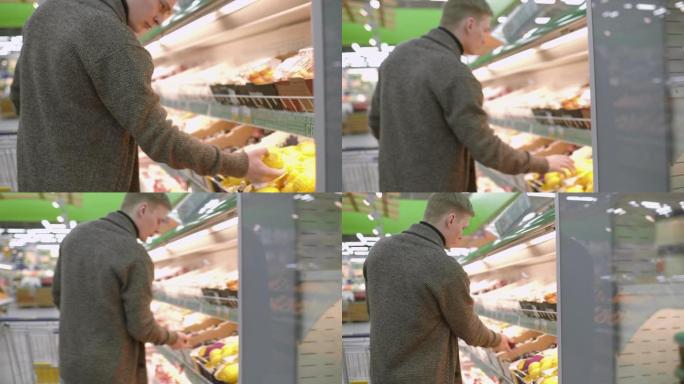 男人在超市里选择水果。