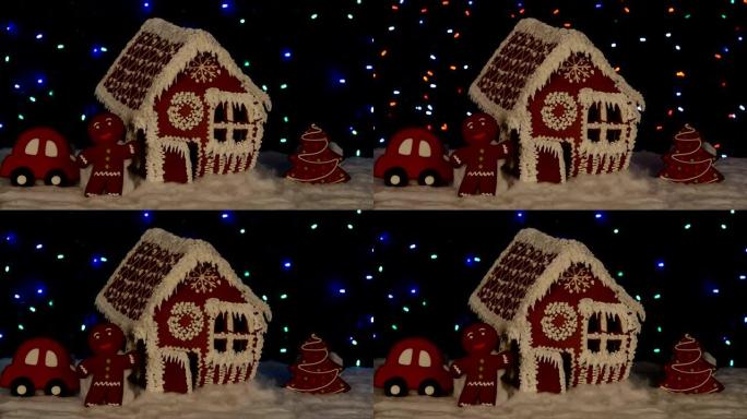 手工制作的可食用姜饼屋，小矮人，新年树，汽车，雪装饰，花环背景照明