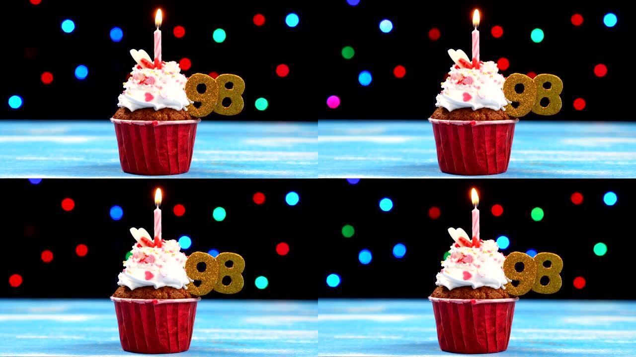 美味的生日蛋糕，蜡烛燃烧，彩色模糊灯光背景上有98号