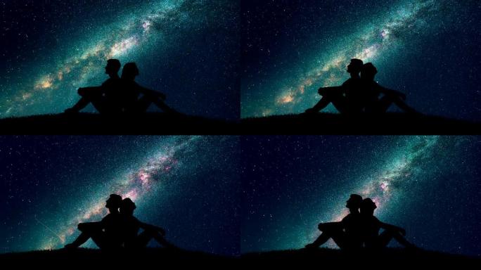 这对夫妇坐在星空背景上的草地上。时间流逝