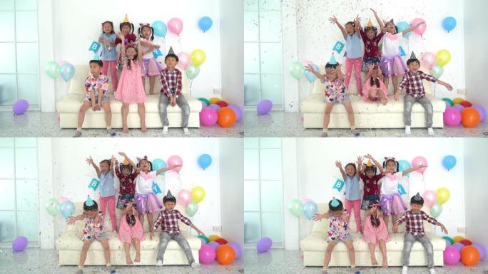 一群亚洲孩子一起庆祝生日派对。生日派对小女孩快乐兴奋的五彩纸屑。