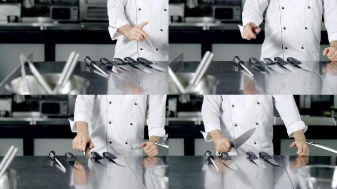 厨师选择刀子在厨房做饭。特写男人手准备做饭。