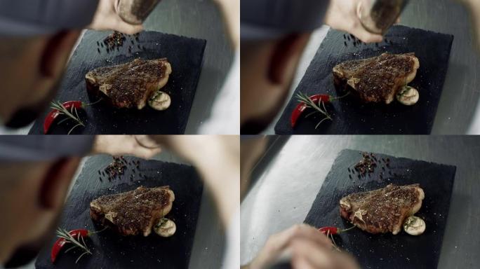 厨师在石菜板上撒上肉。男子手烤烤条纹
