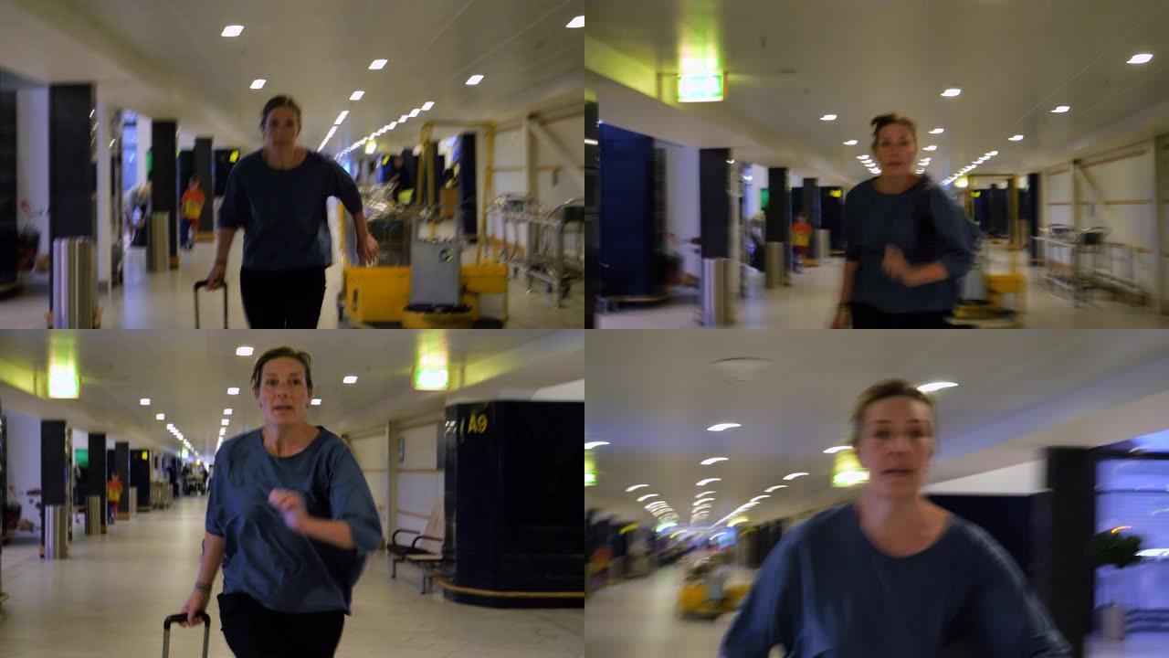 紧张的女人在机场带着手提箱奔跑到达她的大门