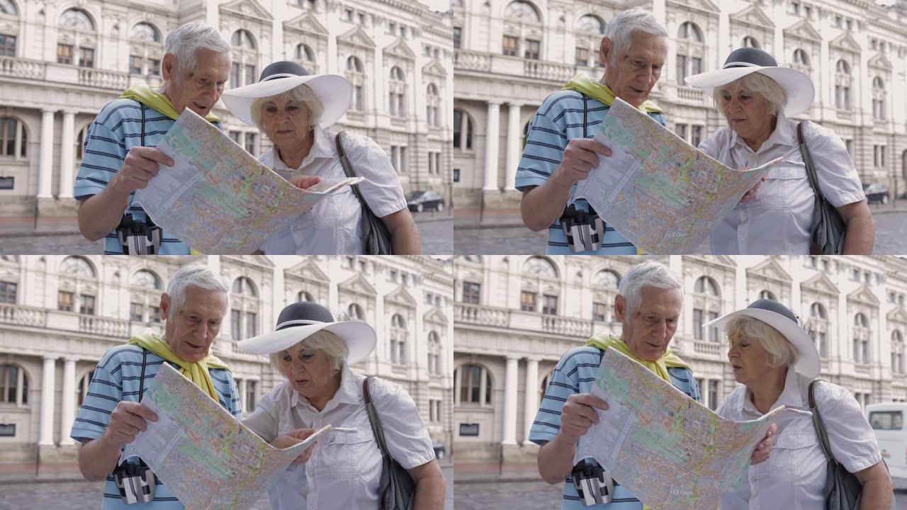高级男性游客用手中的地图向女人问路