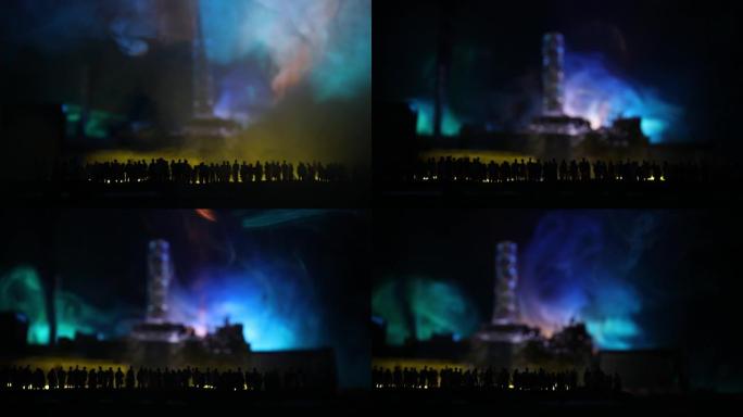 创意艺术品装饰。夜间切尔诺贝利核电站。核反应堆爆炸后废弃切尔诺贝利站的布局。人群看着燃烧的反应堆。选