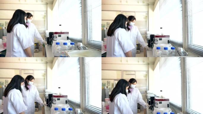 两名科学家在实验室工作的场景慢动作使用蛋白质提纯机，概念科学与技术在实验室