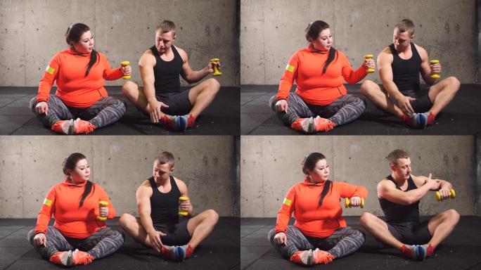积极超重的女人和健康的男人坐在地板上做运动