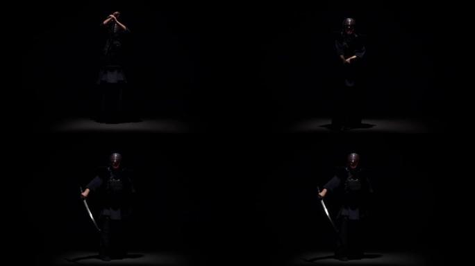 剑道战士在聚光灯下的黑暗工作室用武士刀表演武术。慢动作