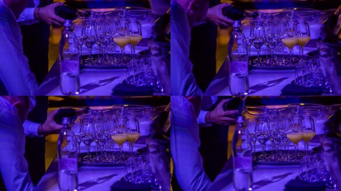 服务员慢慢将高雅的冰凉香槟倒入水晶玻璃杯中