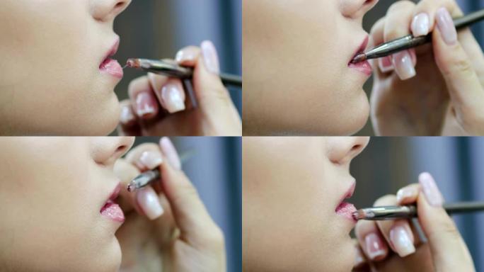 化妆师用唇线绘制嘴唇模型。白天中性色调柔和的妆容