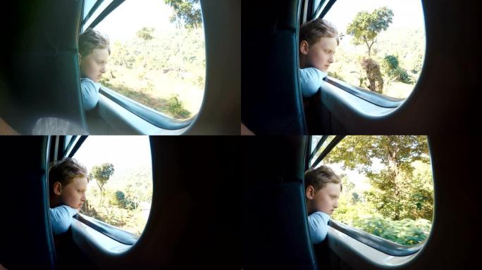 4k金发男孩坐在火车上看着窗外