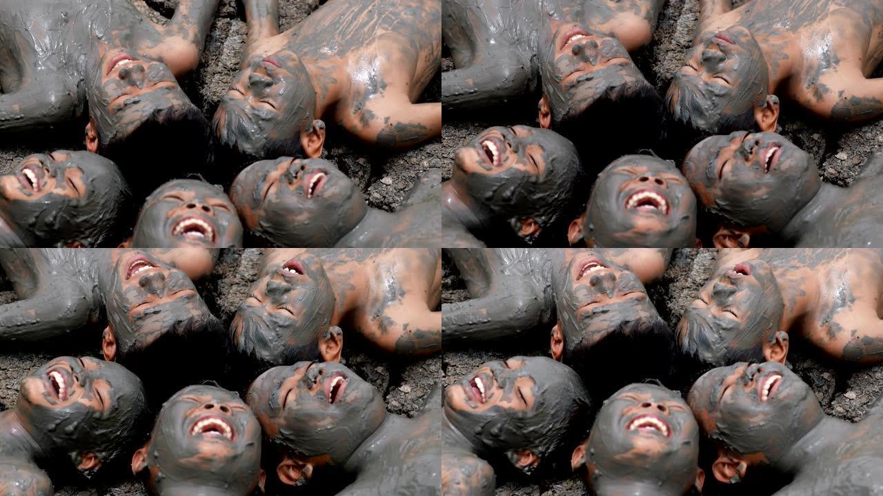 五个农村孩子，肮脏的身体躺在干燥的土壤上，开心地笑在一起。