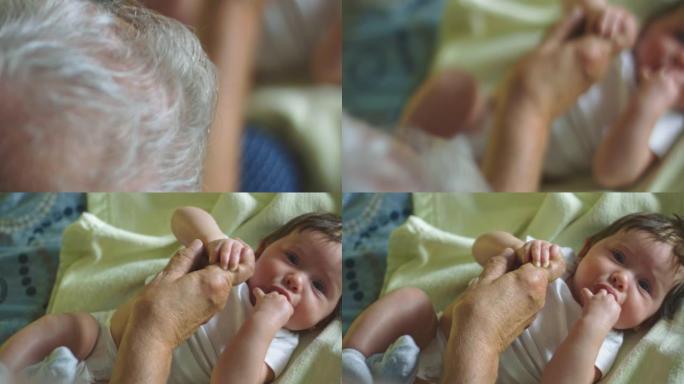 婴儿的慢动作看着相机并握住祖父的手指