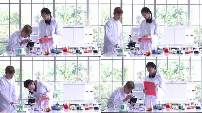 科学家男孩使用显微镜和女孩讲座