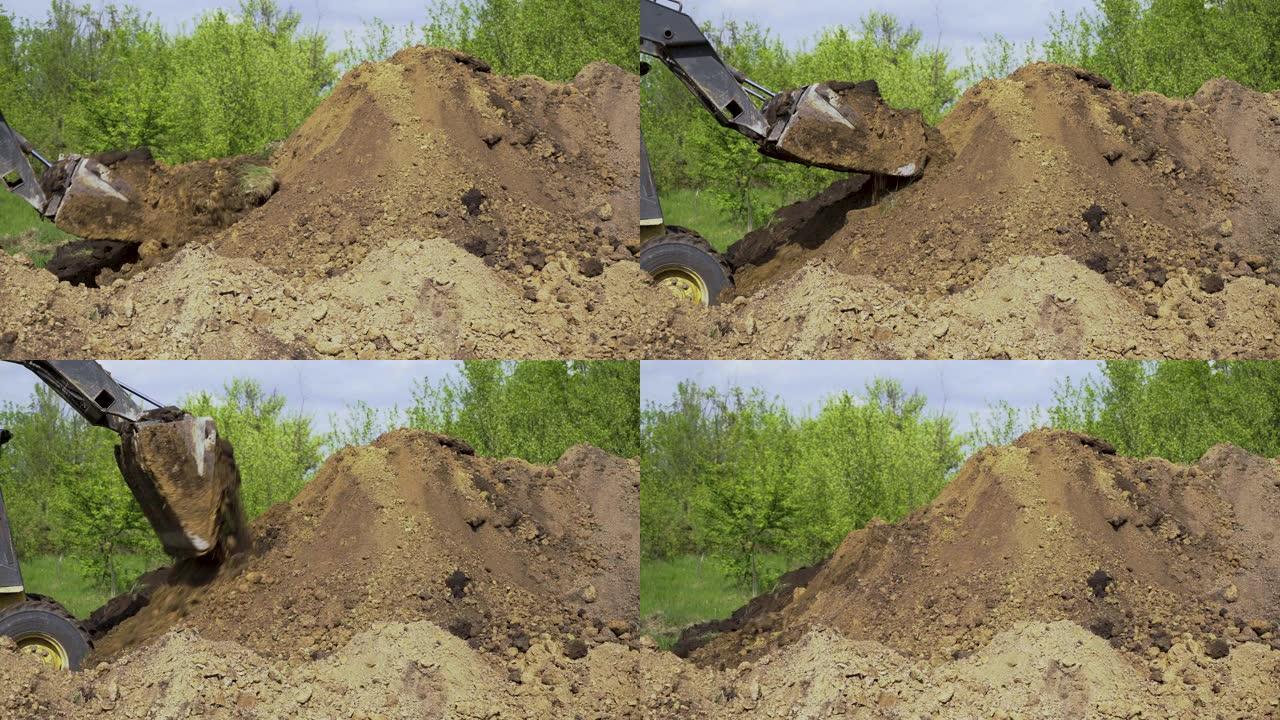 推土机在地面上从铲斗上卸下土壤，背景是花园