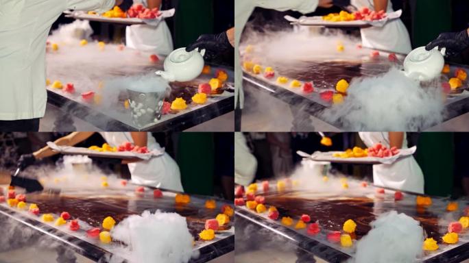 厨师和他的助手正在用蒸汽将水果放在冰淇淋的背景上。