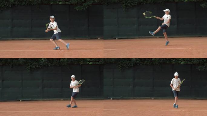 雄心勃勃的网球运动员少年男孩专注于比赛和球拍在红色球场上击球
