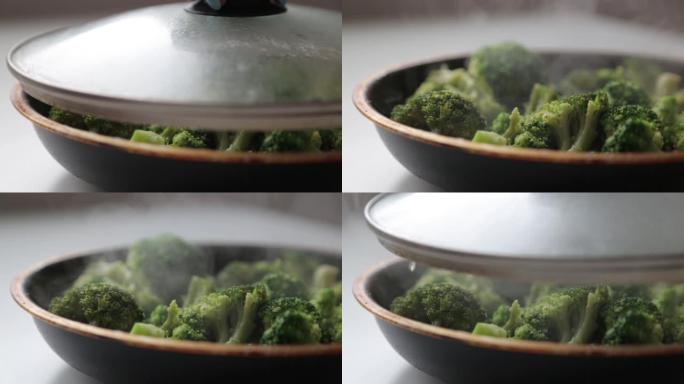 卷心菜西兰花放在平底锅里，里面有油和香料。烹饪新鲜的绿色卷心菜产生的蒸汽和烟雾。