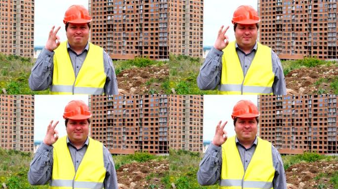 男性建筑工人工头，建筑工地上的工人或建筑师在对相机微笑时表现出好的手势