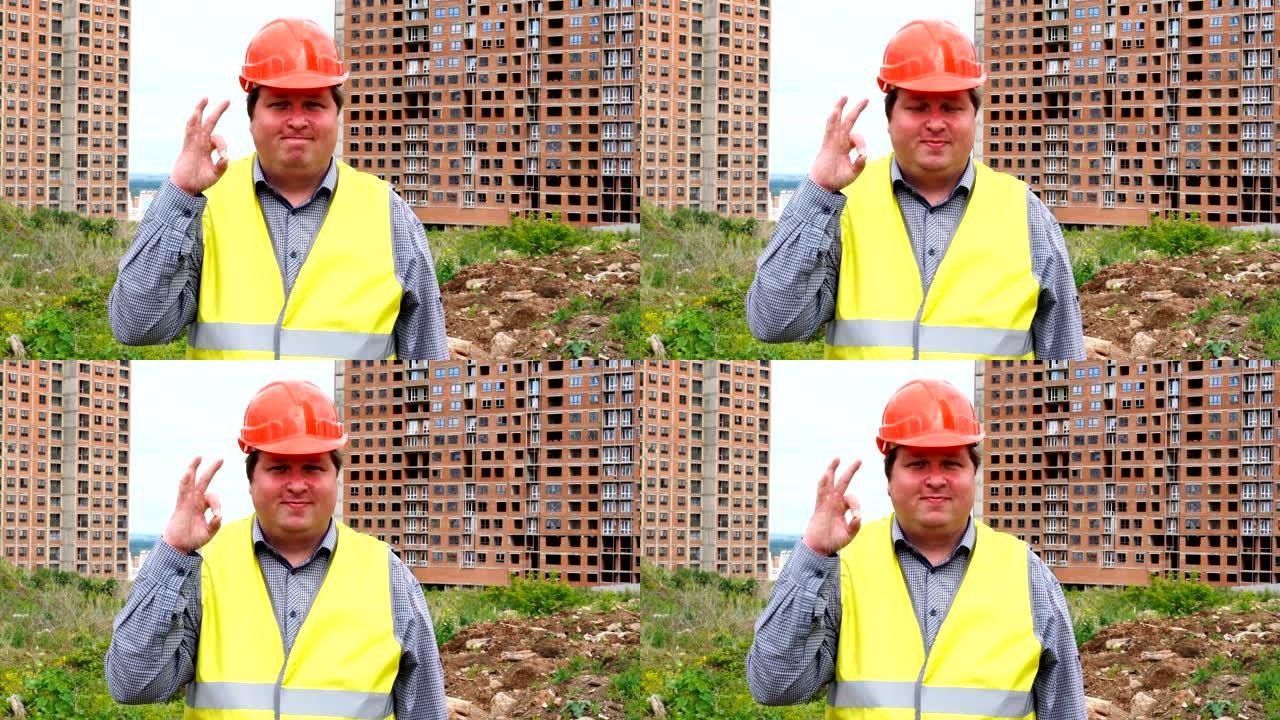 男性建筑工人工头，建筑工地上的工人或建筑师在对相机微笑时表现出好的手势