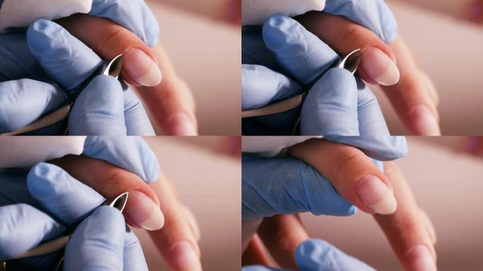 美甲师正在用专业指甲钳切割角质层，用于修指甲。
