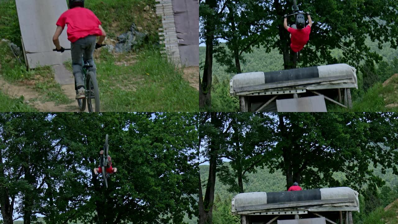 穿着红色衬衫，戴着全脸头盔的山地自行车骑手在慢动作中进行疯狂的后空翻