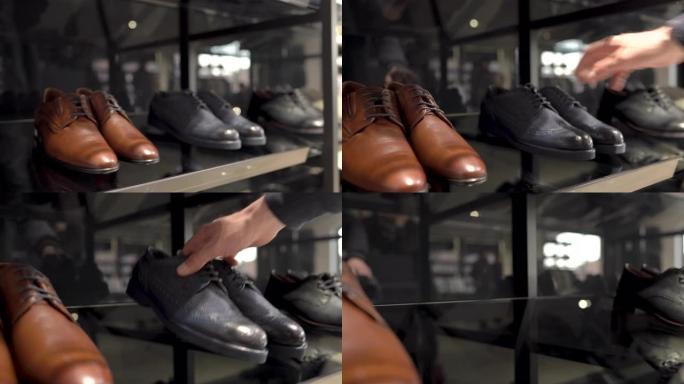 一位男性顾客的特写镜头，从奢侈品时装店的玻璃陈列中拿出经典风格的深蓝色鞋子。接近相机拍摄