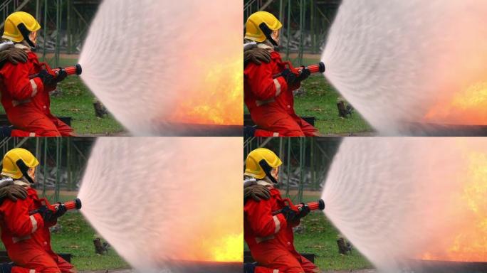FHD 250 fps慢动作宽镜头消防员在安全救援任务，燃烧区域有裂纹的火焰。两名消防员使用软管中的