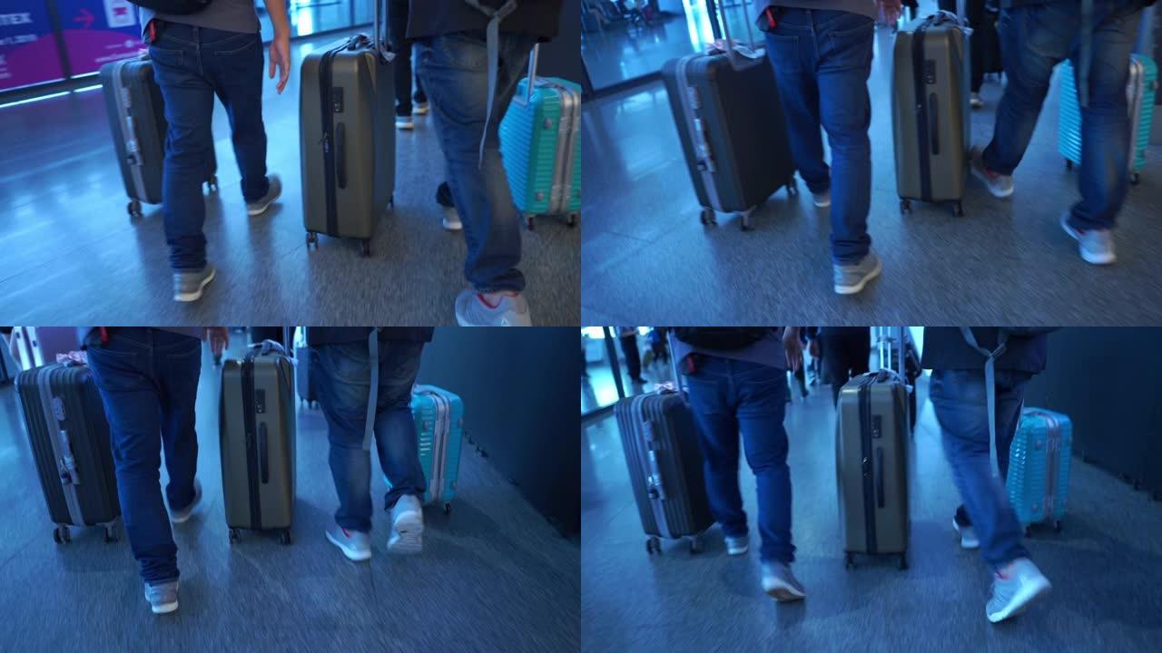 无法识别的人在机场拖着行李