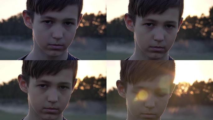 悲伤的男孩同情地看着镜头，无家可归的男孩，脸上的疼痛，特写