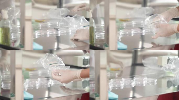 在微生物实验室中，实验室科学家打开干净的培养皿的特写镜头。人体液体样本概念的医学研究
