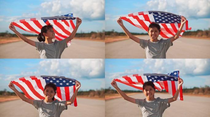 快乐的亚洲小女孩与美国国旗美国庆祝7月4日