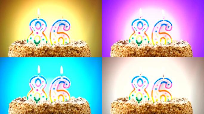 带有燃烧的生日蜡烛的生日蛋糕。86号。背景改变颜色
