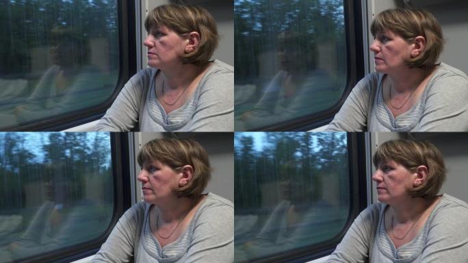 一名坐火车的年轻女子看着窗外
