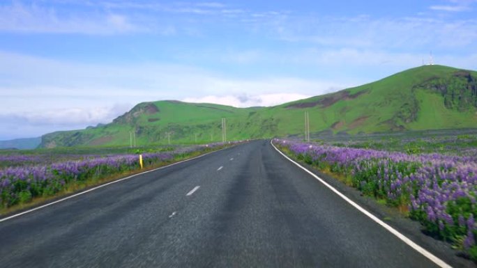 沿着冰岛南部的乡村路行驶的汽车司机的FPV。