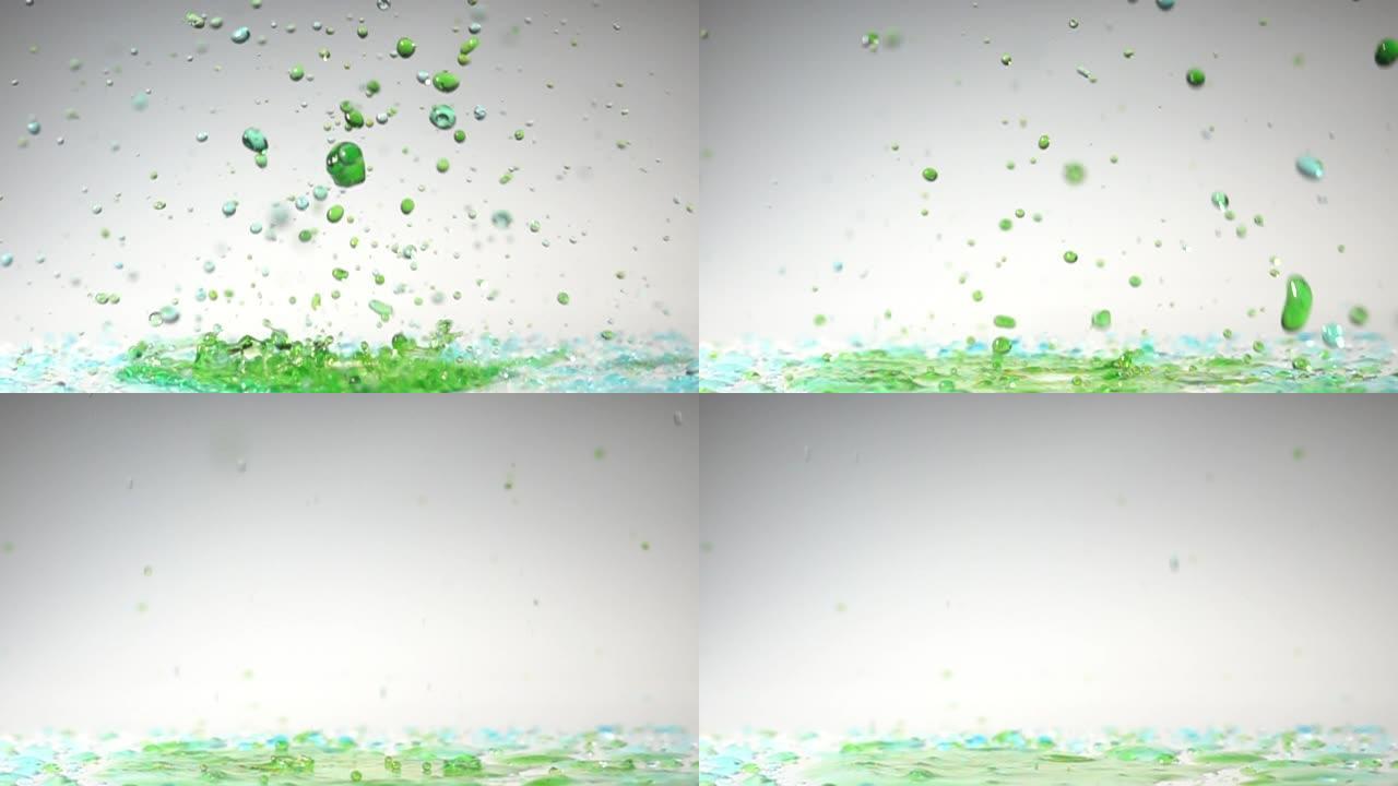 慢动作中白色背景的绿色水舞色