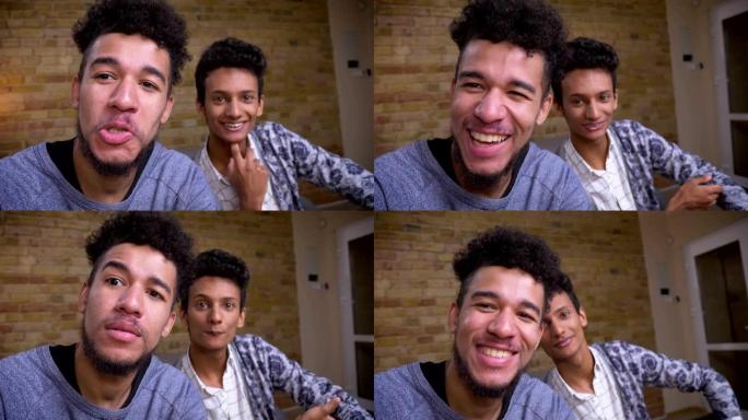 两名年轻的非洲裔美国人和印度男性博客的特写镜头在室内欢快地在摄像机上直播