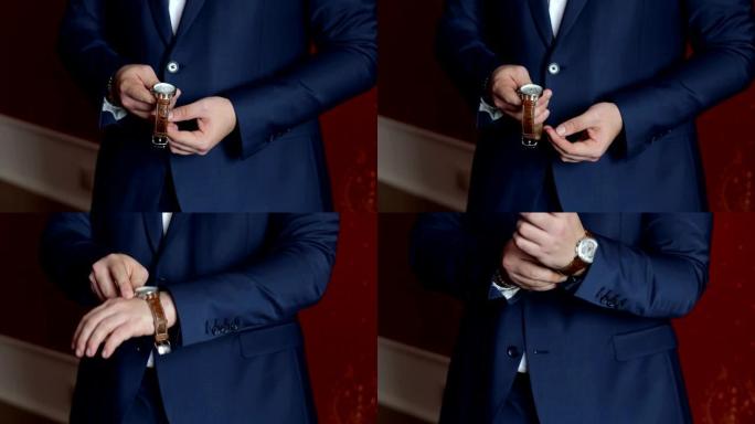 一个穿着蓝色西装的男人的特写把手表系在他的手上。