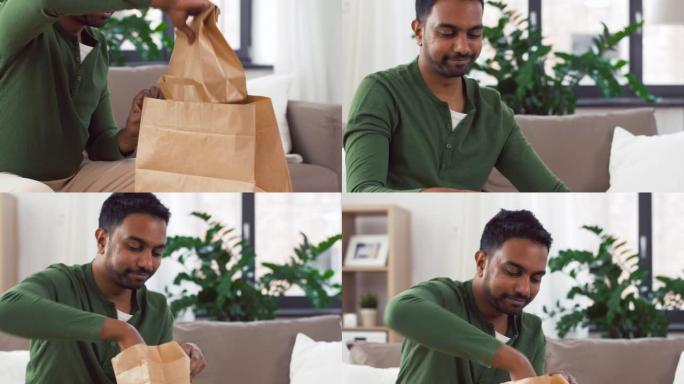 印度男子在家中打开外卖食品的包装
