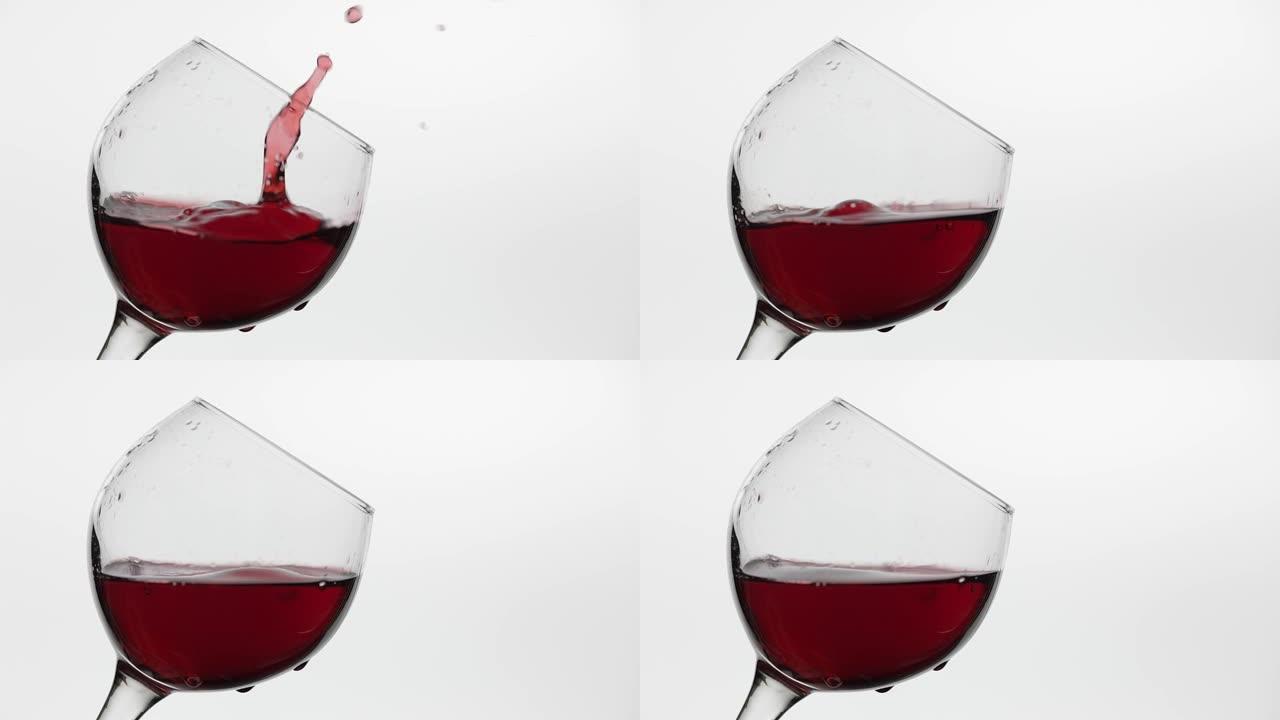 一滴红酒掉在玻璃杯中的特写镜头。白底玫瑰酒