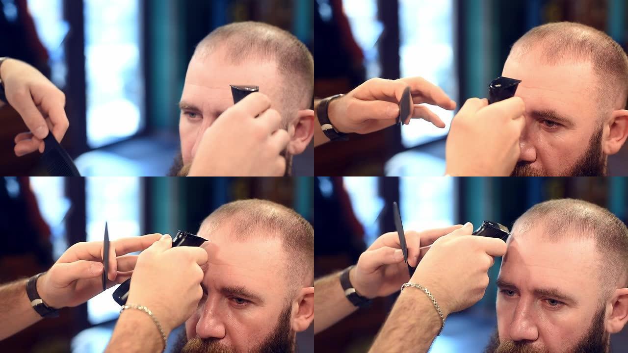 理发师的手梳理和剪断男人头上的头发。使用梳子和电动修剪机