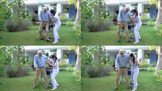 护士帮助用拐杖支持老人从养老院的花园里的轮椅上站起来-录像视频