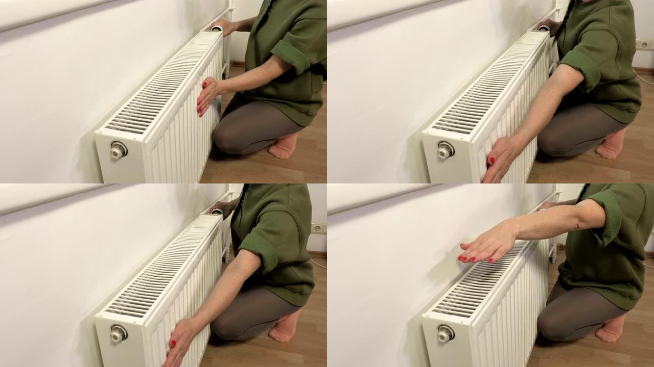女人检查暖气片的加温