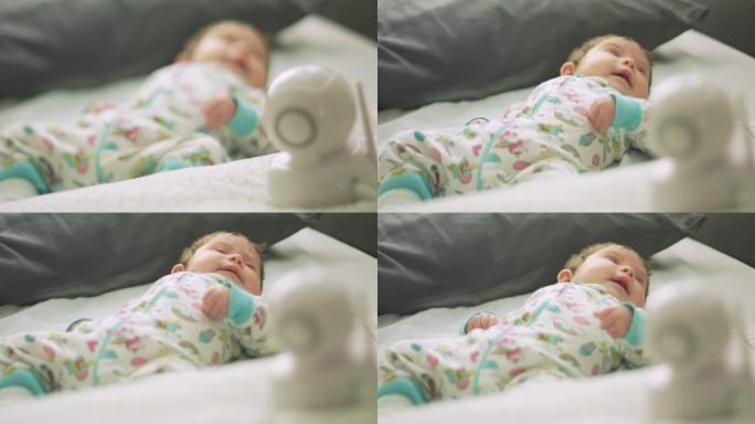 从婴儿监视器向躺在床上的婴儿慢动作
