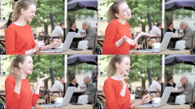 坐在咖啡馆露台上的年轻女子在线视频聊天