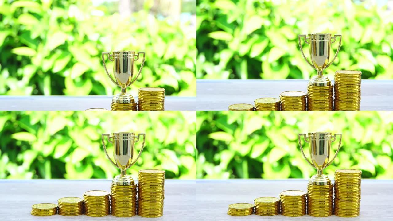 业绩冠军管理与奖励财务概念投资: 金币上排的金色奖杯，祝贺业务成功，竞争领导力生活灵感